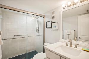 a white bathroom with a sink and a shower at Land's End 5-204 Gulf-Bay Front - Premier in St. Pete Beach