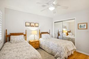 a bedroom with two beds and a ceiling fan at Land's End 5-204 Gulf-Bay Front - Premier in St. Pete Beach