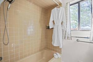a robe hanging in a bathroom with a bath tub at Taos Pine Home in Taos +39 photos