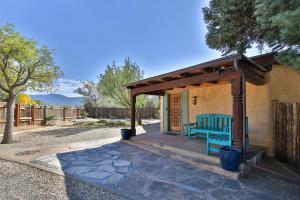 a blue bench sitting outside of a house at Taos Pine Home in Taos