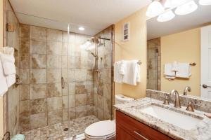 a bathroom with a shower and a sink and a toilet at Land's End 6-303 Beach Front - Premier in St Pete Beach +50 photos