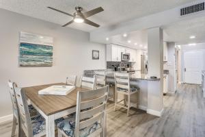 a dining room and kitchen with a table and chairs at Land's End 4-202 Bay Front - Premier in St Pete Beach
