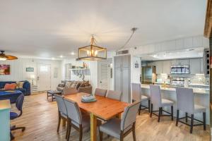 a dining room and living room with a table and chairs at Pelican Pointe 2C in Clearwater Beach