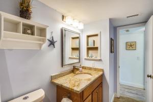 a bathroom with a sink and a toilet and a mirror at Pelican Pointe 2C in Clearwater Beach