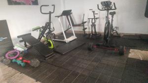 a gym with bikes and exercise equipment in a room at HOTEL EMPRESARIAL Arcoiris de mi llano in Paz de Ariporo