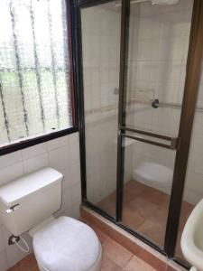 a bathroom with a shower and a toilet and a sink at Finca San Antonio del Tequendama in San Antonio del Tequendama +24 photos