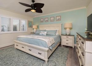 a bedroom with a bed and a ceiling fan at Land's End 4-306 Bay Front - Premier in St Pete Beach +71 photos