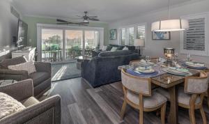 a living room with a table and a dining room at Land's End 4-306 Bay Front - Premier in St Pete Beach