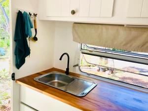 a kitchen with a sink and a window at Green Anchorage Bush Stay in Agnes Water