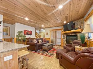 a living room with leather furniture and a fireplace at 6 A Timberwolf Lodge by SkyRun Park City in Park City