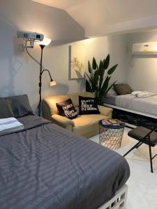 a bedroom with a bed and a living room with a couch at Gray Room The White Haven In Clark in Angeles