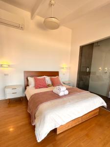 a bedroom with a large bed with two towels on it at Oceanview Sunset Villa Hallett Cove 3BR 2Bath Large Deck Free Parking in Halletts Cove