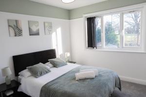 a bedroom with a bed with two towels on it at Lymer House in Wolverhampton