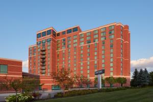a tall red building with a sign in front of it at Courtyard by Marriott Ottawa East in Ottawa