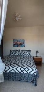 a bedroom with a bed and a ceiling fan at Amplo Apartamento in Rio de Janeiro