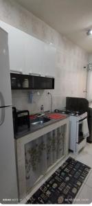 a kitchen with a sink and a stove at Amplo Apartamento in Rio de Janeiro +9 photos
