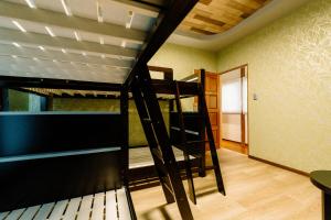 a room with two bunk beds and a hallway at Smooth & Living in Ueda