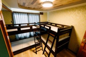a room with three bunk beds in it at Smooth & Living in Ueda