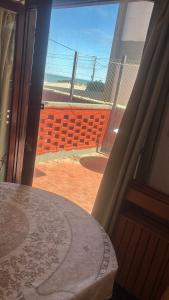 a room with a window looking out at a soccer field at Departamento frente al mar y con vistas a la playa in Villa Gesell