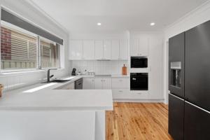 A kitchen or kitchenette at Morgan Abode - Walk to CBD, Modern Escape