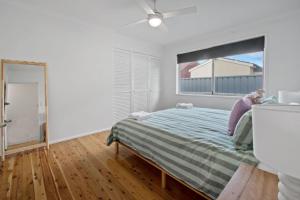 A bed or beds in a room at Morgan Abode - Walk to CBD, Modern Escape