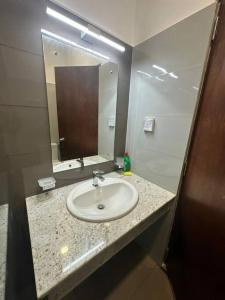 a bathroom with a sink and a mirror at Luxury Golf and Relaxation in Gonapola +17 photos