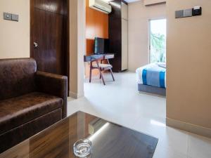 a room with a couch and a bed and a desk at Resort Atlantis in Dhalpur +24 photos