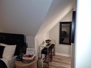 a room with a bed and a table and a mirror at St Paul Fry Street Den Tower Suite #3 in Saint Paul +9 photos