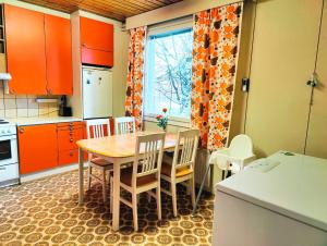 a kitchen with a table and chairs and a window at Authentic Countryhouse at the Reindeer Farm in Tanhua