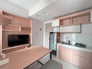 a kitchen with wooden cabinets and a counter top at Bangulbobo 2br tower Ishikawa in Sungaitahang