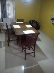 a wooden table and chairs in a room at Kangol's studio apartment in Montego Bay