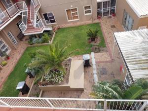 an aerial view of a yard with palm trees at Azzure Apartments 4 sleeper Strand in Strand