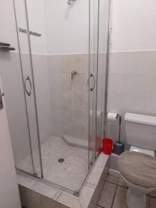 a bathroom with a shower and a toilet at Azzure Apartments 4 sleeper Strand in Strand +14 photos