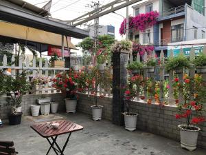 a bunch of potted plants in pots on a wall at Motel Minh Thảo in Danang