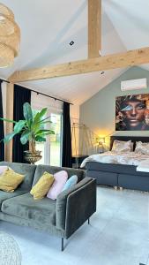 a living room with a couch and a bed at Slapen bij de Zeeuwse Lala in IJzendijke