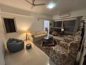 a living room with a couch and chairs and a table at The Grand Ganga, Peaceful, Homely, Near Sangam in Prayagraj