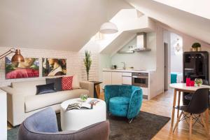 ein Wohnzimmer mit einer Couch und Stühlen und einem Tisch in der Unterkunft Palacio Conde Miranda in Madrid