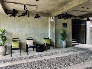 a group of chairs sitting on a porch at 518Hotel in San Josef