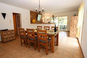 a kitchen with a dining room table and chairs at La Villa Noyau Doux in Ampuis