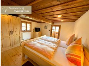 a bedroom with a bed in a room with wooden ceilings at Waldlerhof in Patersdorf