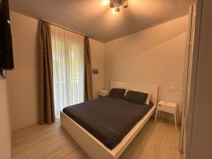 a bedroom with a bed and a large window at Luxury Lake View 2 Bed in Padenghe sul Garda +63 photos