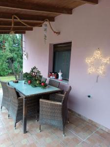 a patio with a table and chairs and a star decoration at Cottage House in Kardítsa