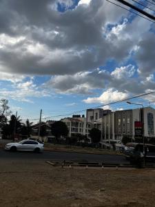 a white car driving down a street with buildings at KHAL HOST HUB in Nairobi