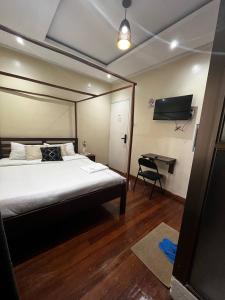 a bedroom with a bed and a desk in it at KHAL HOST HUB in Nairobi