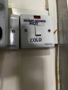 an electric refrigerator with an instant shower coil on it at KHAL HOST HUB in Nairobi