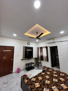 a bedroom with a bed and a ceiling fan at Parshukshetra Homestay in Bhuj +2 photos