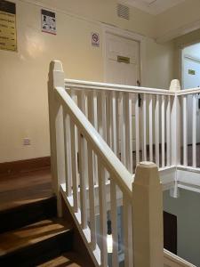 a staircase with white railings in a house at KHAL HOST HUB in Nairobi