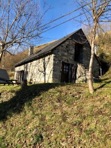 an old stone house on top of a hill at Bergerie authentique au cœur des Pyrénées in Eaux-Bonnes