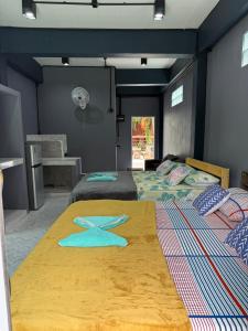 a bedroom with two beds with blue walls at P'Un House in Ko Tao +251 photos
