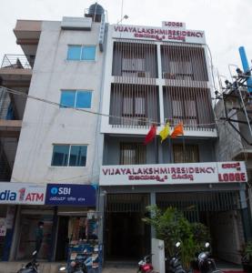 Un edificio con letreros en el costado. en HOTEL VIJAYA LAKSHMI RESIDENCY - YESHWANTHPUR, en Bangalore